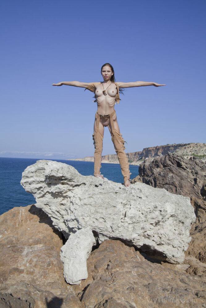 Solo girl Alisa strikes great nude poses on a rocky seaside cliff - #4