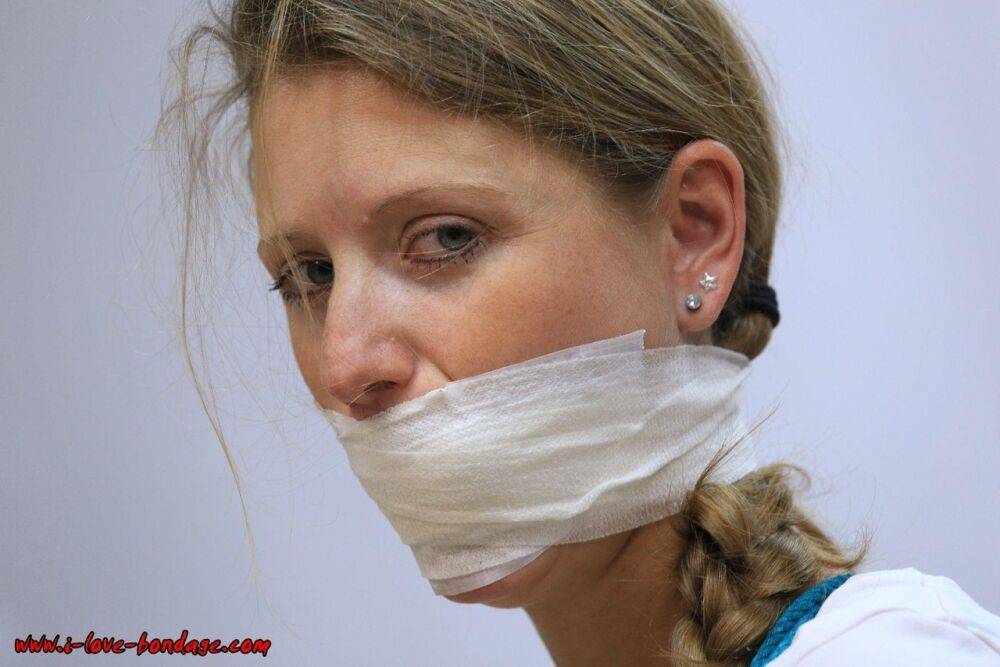 Clothed woman sports a pigtail while being gagged and tied up with rope - #7