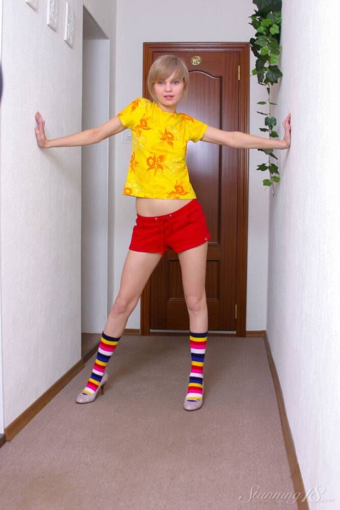 Cute blonde teen Cindy B gets naked in a hallway in multi coloured socks - #3