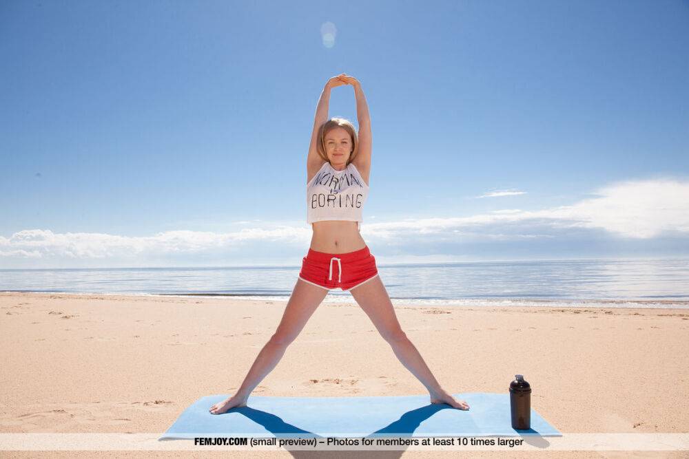 Nice teen Lee D gets totally naked during a yoga routine on the beach - #13