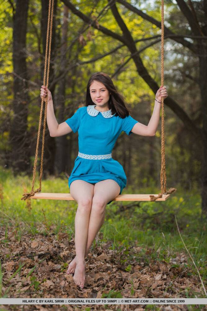 Young brunette Hilary C is encouraged to get naked on swing set in forest - #10