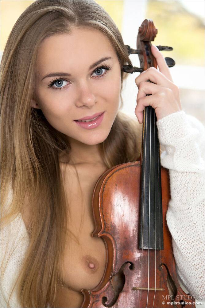 Young blonde strikes great nude poses while playing a violin - #3