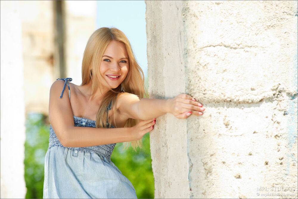 Beautiful blonde girl with long legs takes off her dress on old factory site - #4