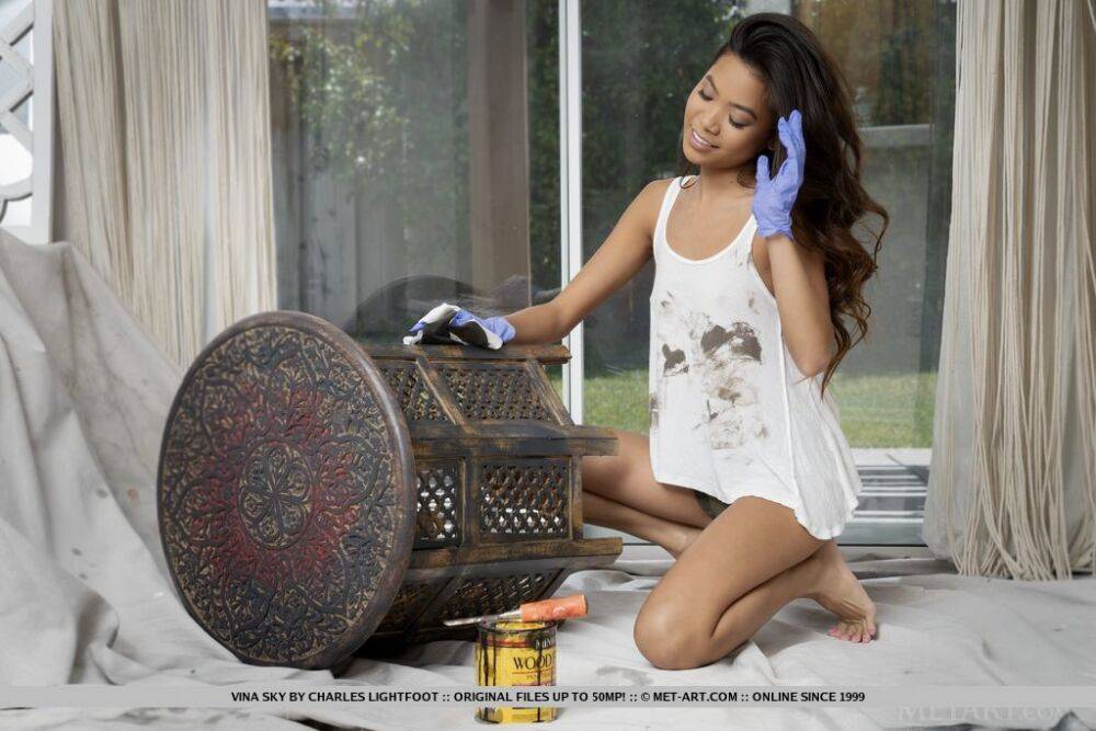 Young Asian girl Vina Sky gets completely naked while refinishing furniture | Photo: 992747