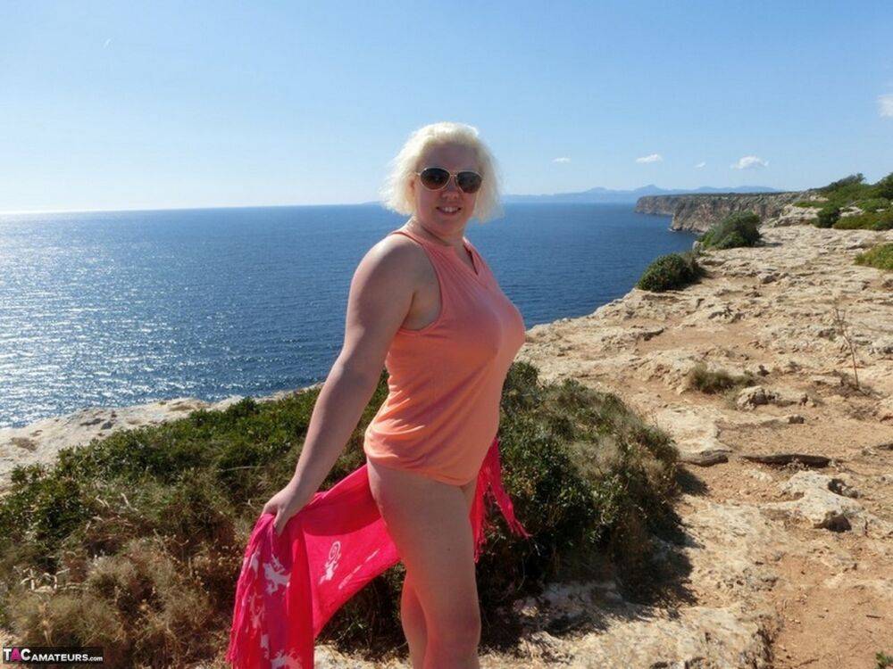 Mature plumper Barby gets naked while visiting a Spanish tourist site - #1