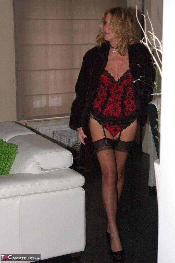 Blonde mature slut Kyra flaunting long legs in red lingerie & black stockings - #15