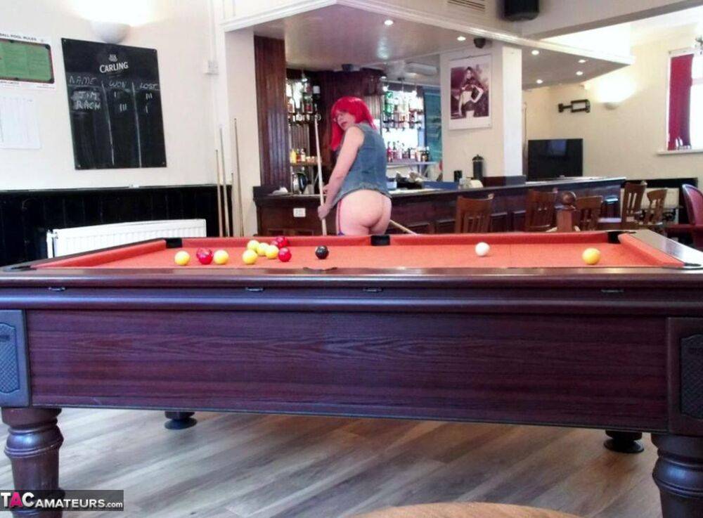 Redheaded amateur Barby Slut exposes her tits and ass while tending bar - #10