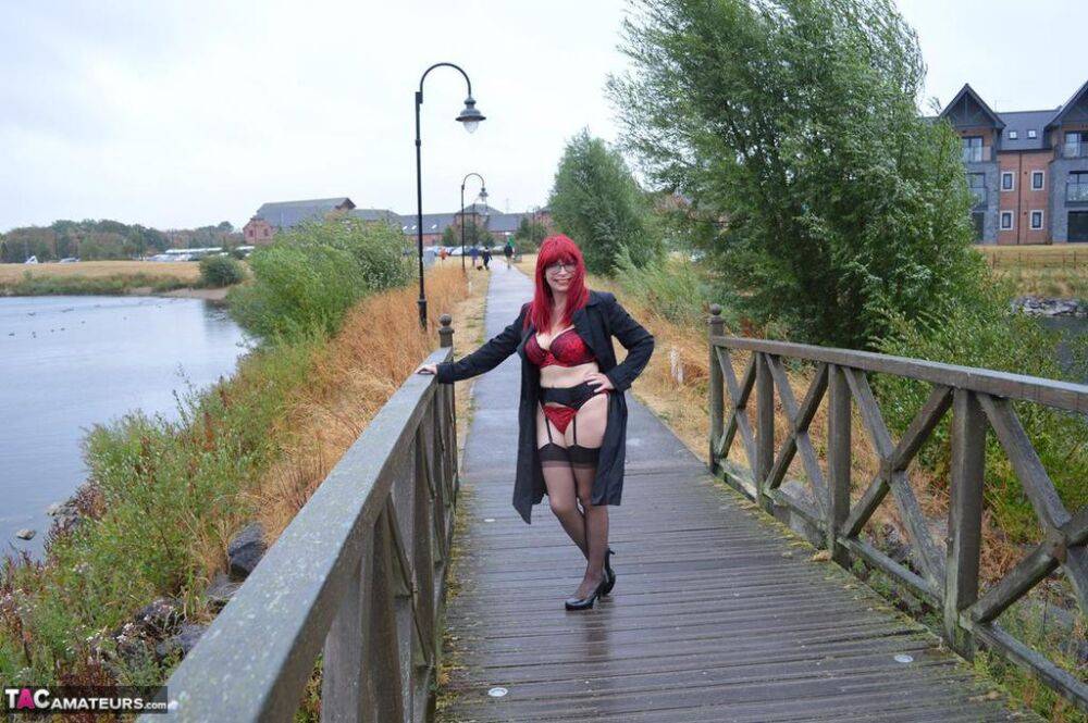 Mature redhead Barby Slut gets naked in public places on a wet day - #6