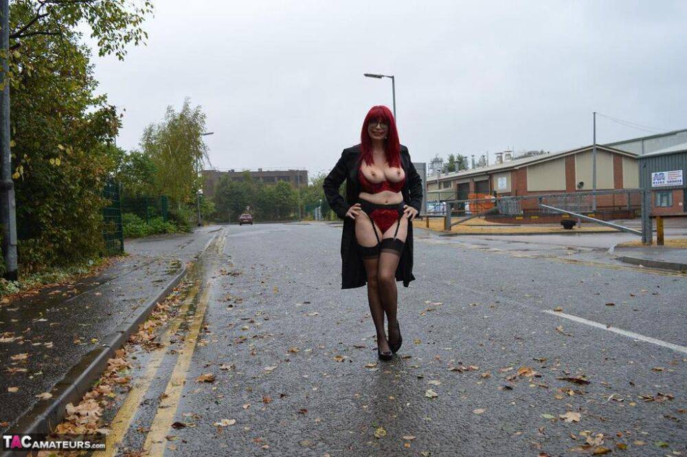 Mature redhead Barby Slut gets naked in public places on a wet day - #8