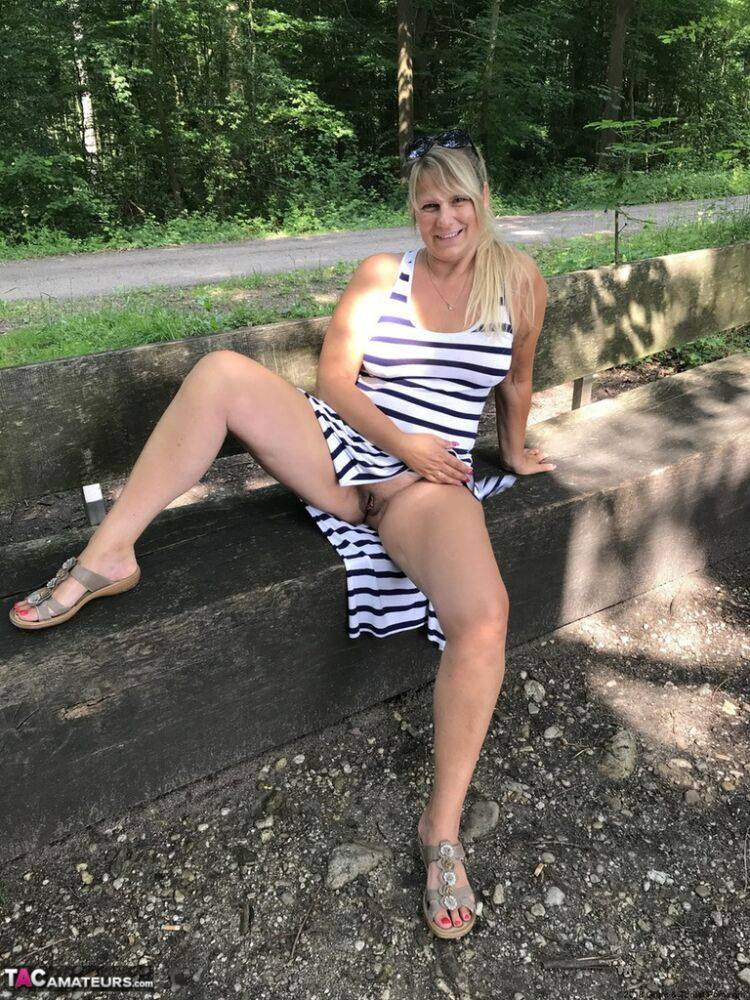 Mature amateur shows her big boobs and butt on bench in the forest - #14