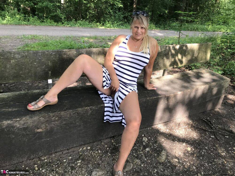 Mature amateur shows her big boobs and butt on bench in the forest - #2