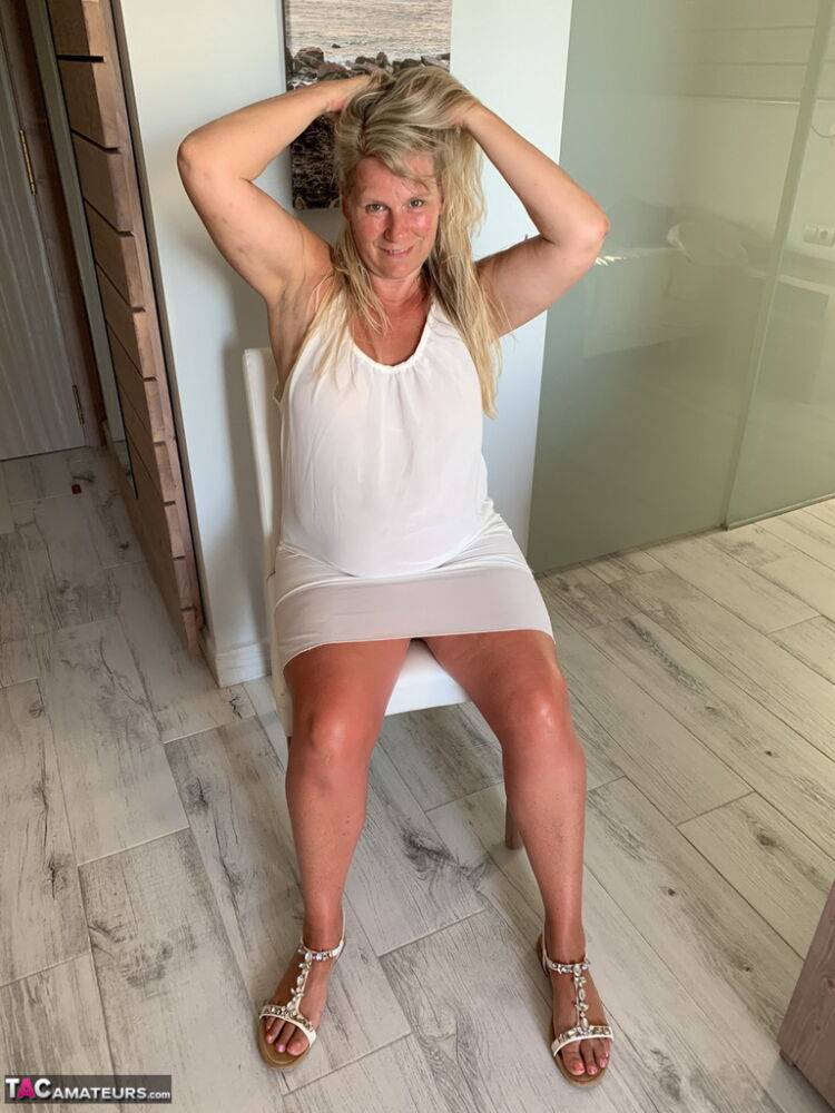 Thick older woman Sweet Susi exposes tan lined tits after hiking up her dress - #15