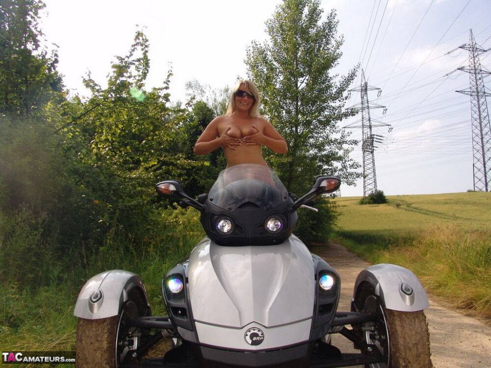 Middle-aged blonde Sweet Susi rides a three wheeled motorcycle while naked - #13