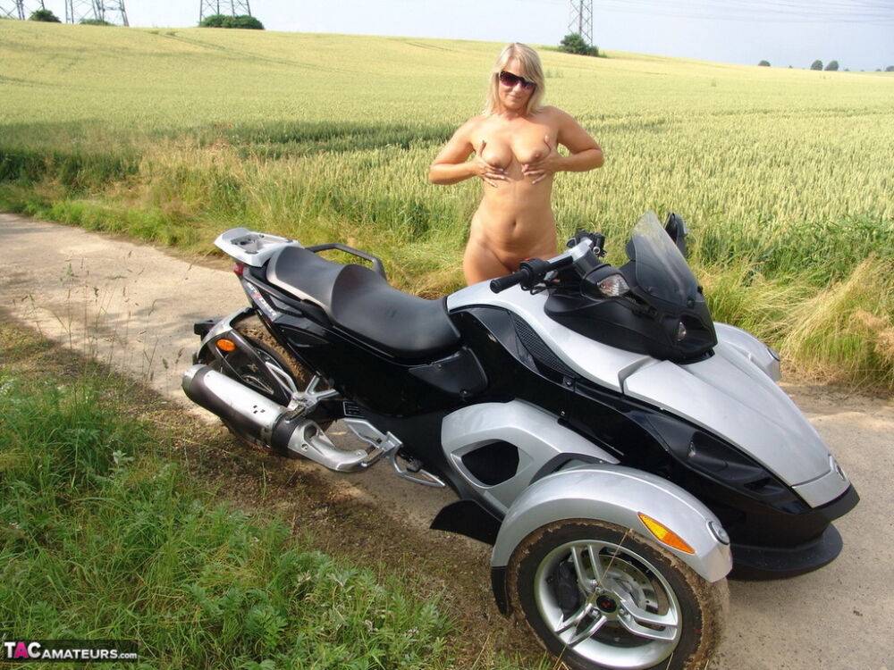 Middle-aged blonde Sweet Susi rides a three wheeled motorcycle while naked - #16