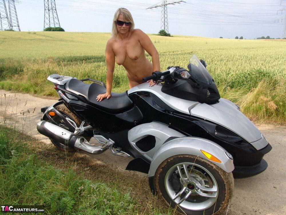 Middle-aged blonde Sweet Susi rides a three wheeled motorcycle while naked - #2