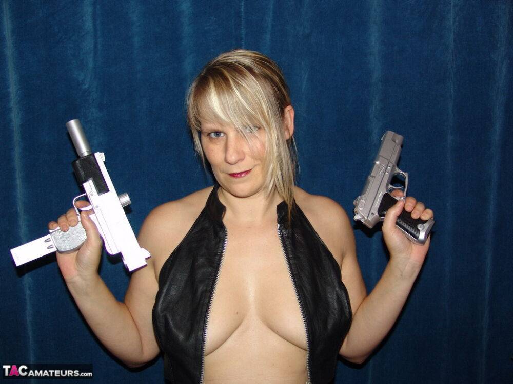 Blonde amateur Sweet Susi holds handguns while getting naked in long boots - #16