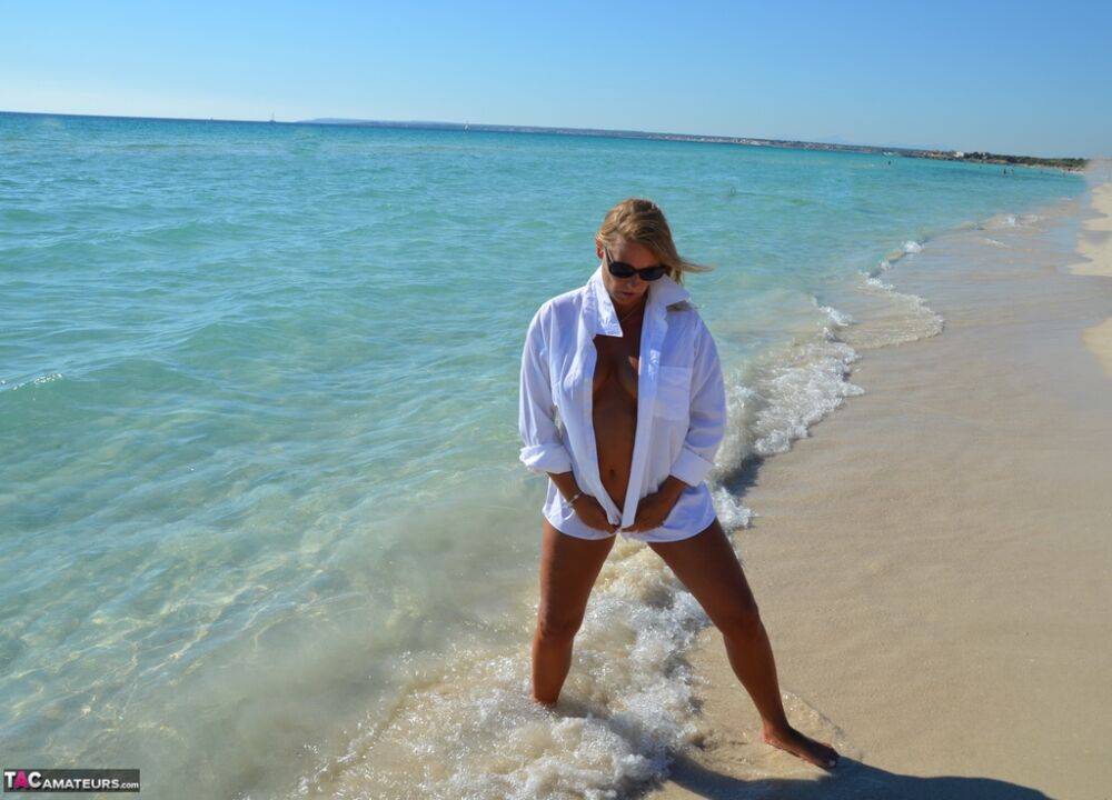 Blonde amateur Sweet Susi steps into the ocean while naked in a white shirt - #7