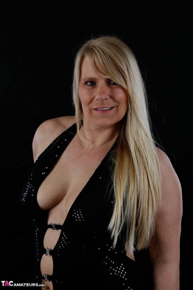 Older blonde Sweet Susi displays her inviting cleavage in a long gown - #3
