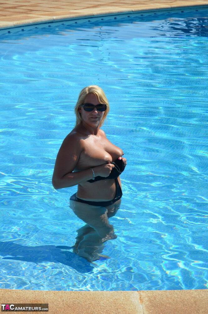 Middle-aged blonde Sweet Susi releases her boobs from a swimsuit in a pool - #4