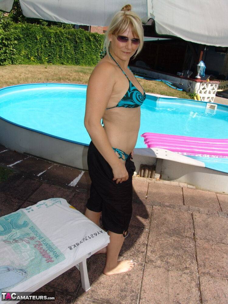 Blonde amateur Sweet Susi removes her bikini to skinny dip in a swimming pool - #1