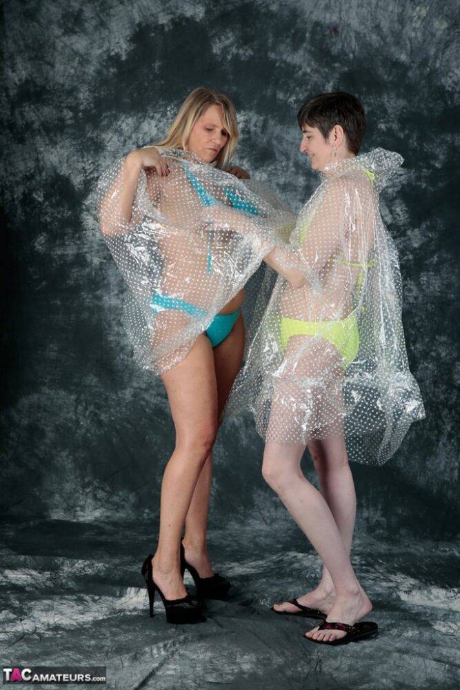 Blonde amateur Sweet Susi and her lesbian lover hump each other in raincoats | Photo: 1330632