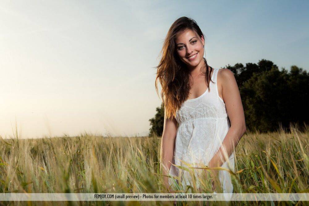 Thin brunette model Lorena G pulls off a cotton dress for nude poses in grass - #1