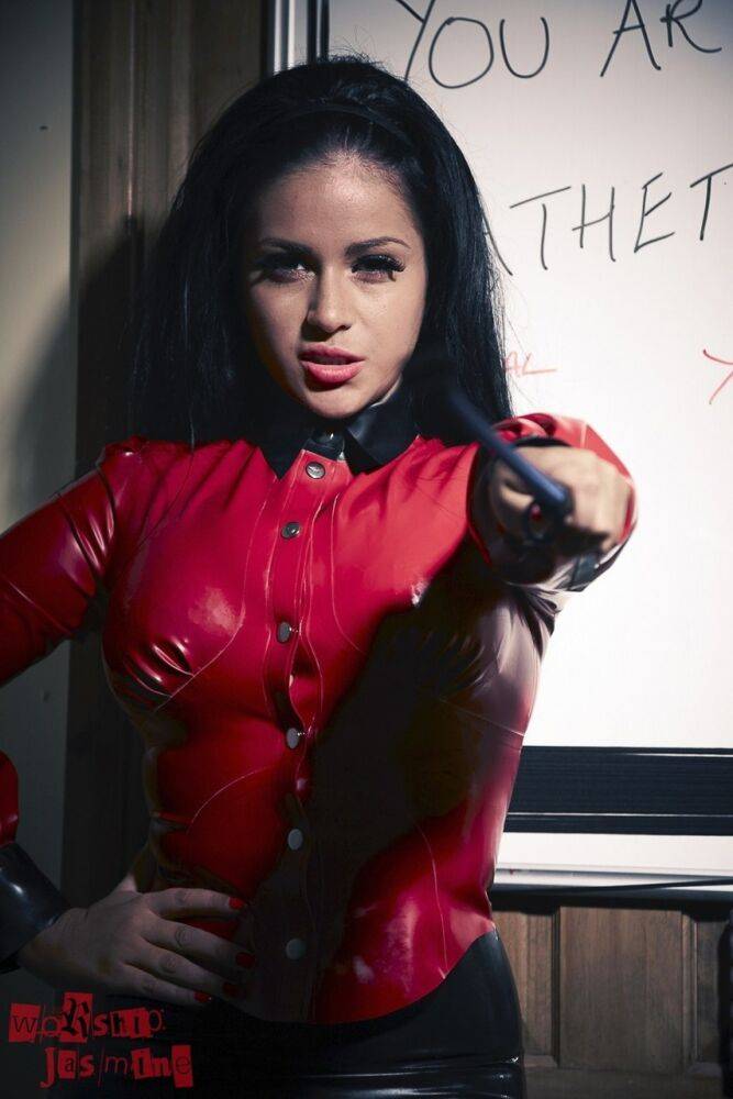 Dominant brunette Jasmine Jones flexes a crop while removing latex clothing - #12