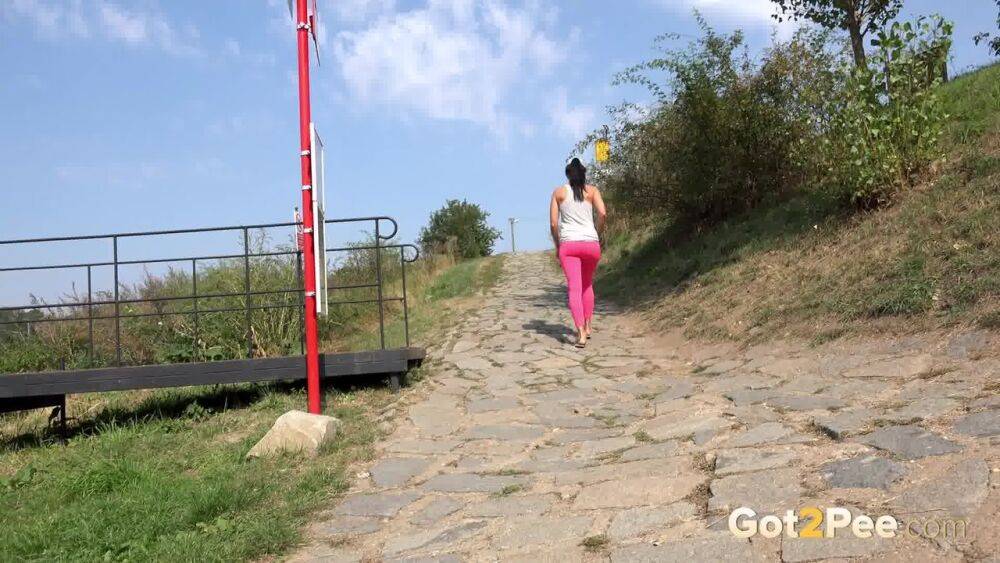 Distressed female Kayla pulls down pink leggings to pee on stone steps - #6