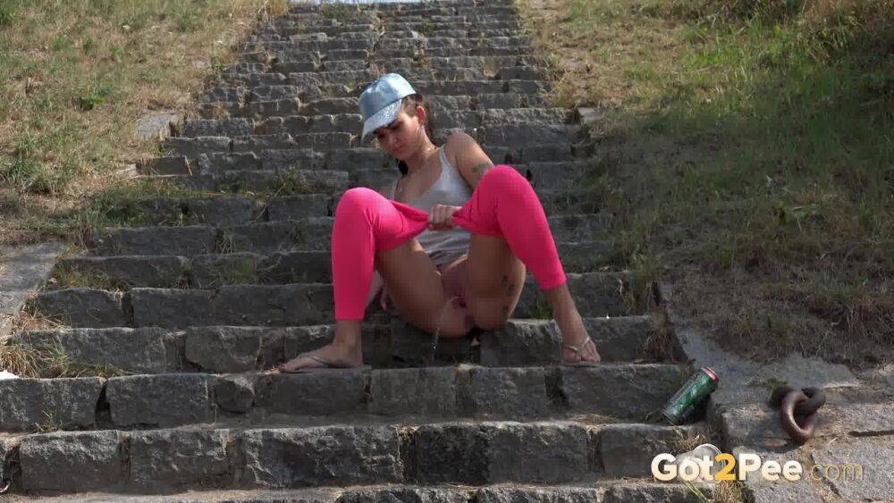 Distressed female Kayla pulls down pink leggings to pee on stone steps - #5