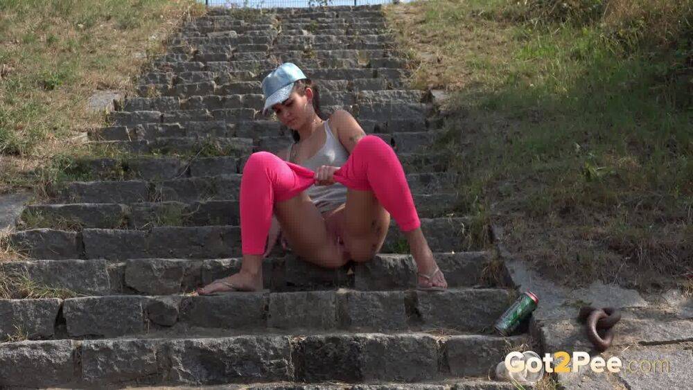 Distressed female Kayla pulls down pink leggings to pee on stone steps - #3