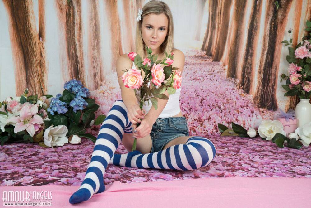 Young looking blonde Pink rolls off striped thigh highs to get totally naked - #1