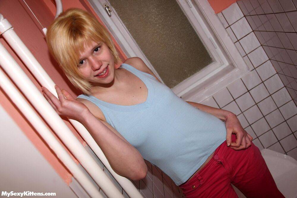 Strawberry blonde teen rubs her bald slit in the bathroom in pink socks - #13