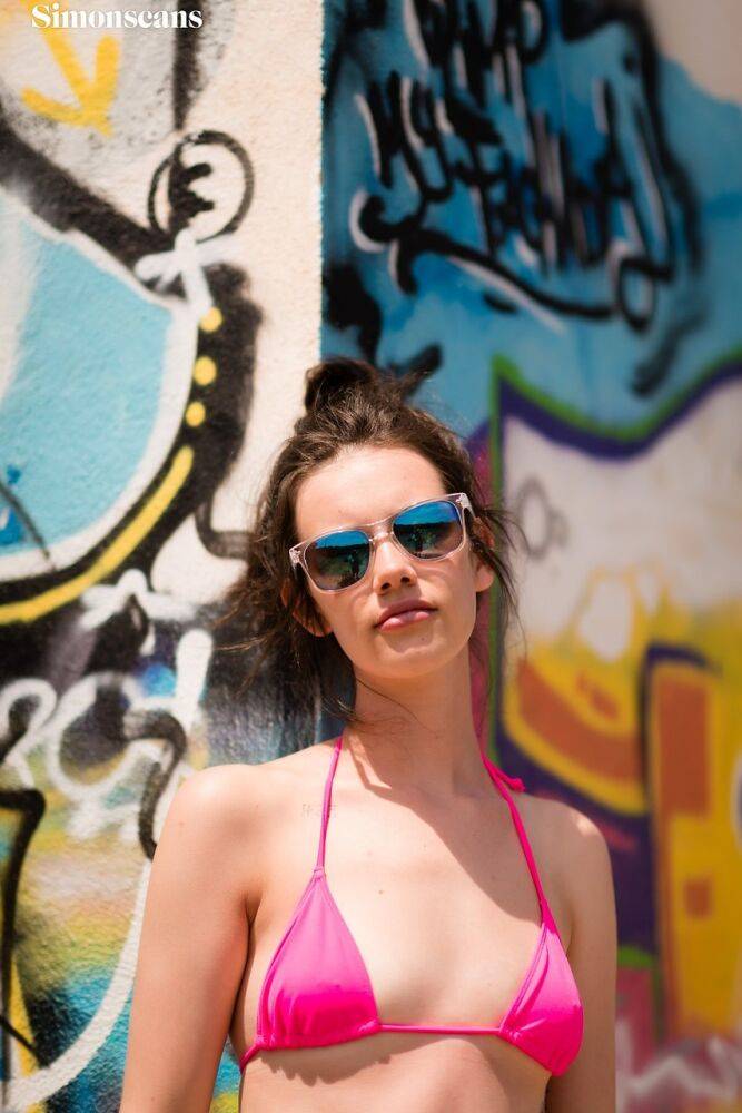 Amateur girl Violet takes off her pink bikini in front of graffiti - #6