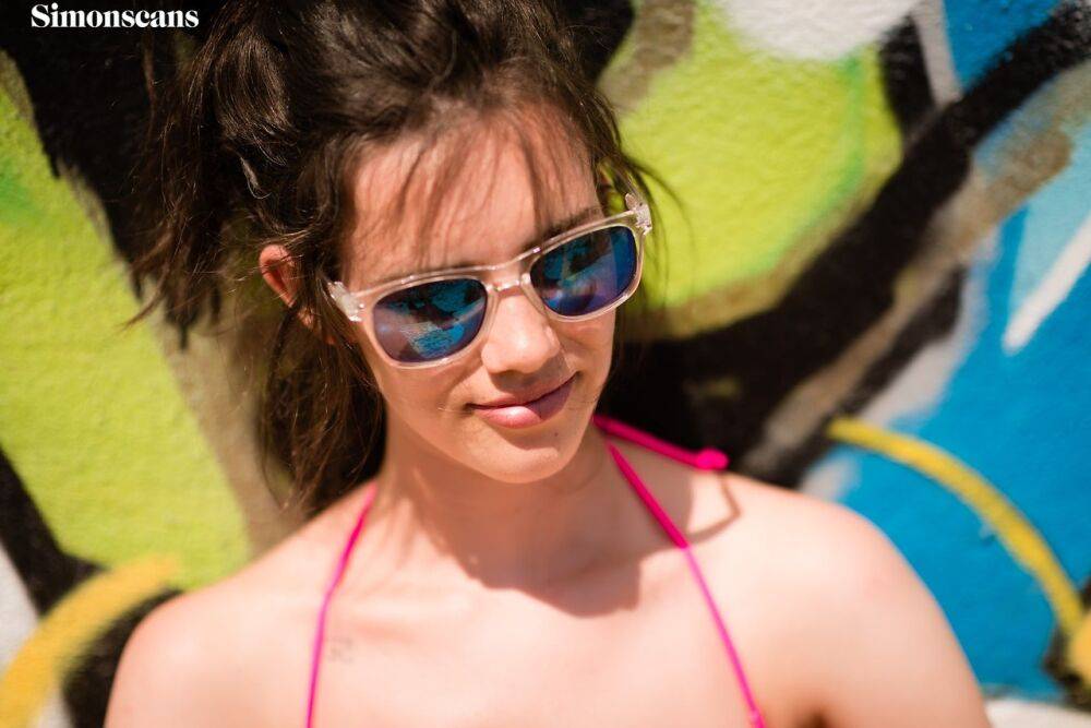 Amateur girl Violet takes off her pink bikini in front of graffiti - #7