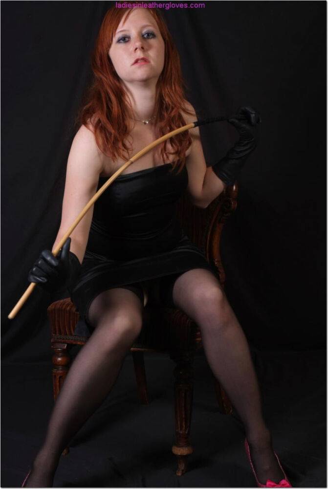 Natural redhead holds a cane with leather gloves while exposing her pink slit - #6