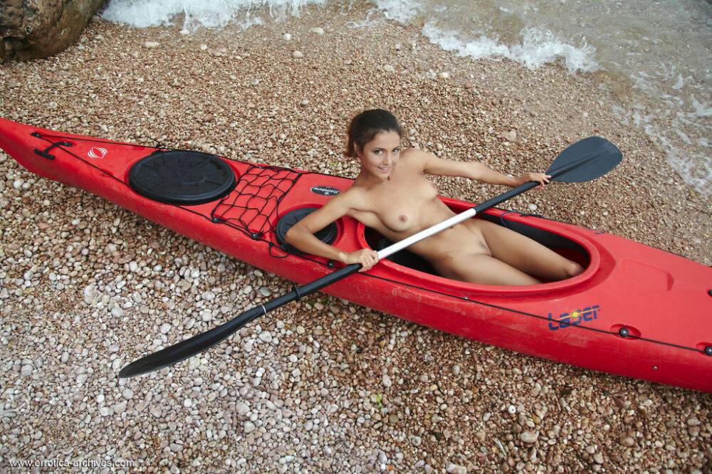 Butt naked babe Sati poses in the kayak on the wild beach - #12