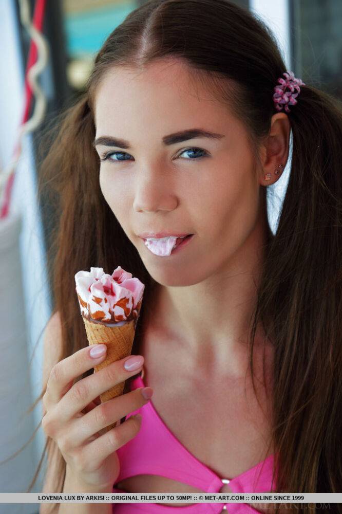 Young looking teen Lovenia Lux eats an ice cream treat before posing naked - #10