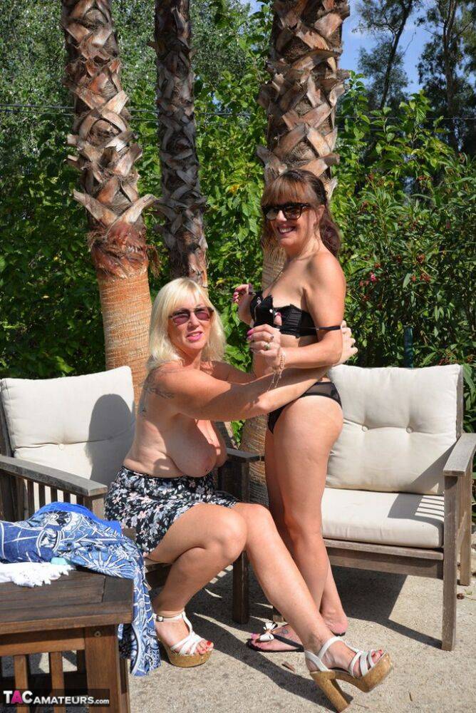 Overweight lesbians in sunglasses help each other get naked on wooded patio - #9