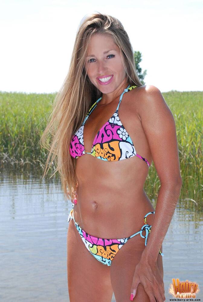 Petite blonde Lori Anderson peels off her bikini in front of a marsh - #3