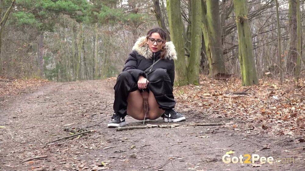 Solo girl Natasha Ink squats for a pee on a dirt road in glasses and a coat - #7