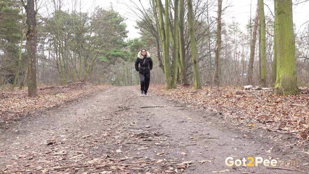 Solo girl Natasha Ink squats for a pee on a dirt road in glasses and a coat - #13