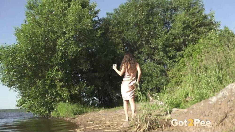 Tall brunette Sasha S squats for an urgent piss on the bank of a lake - #1