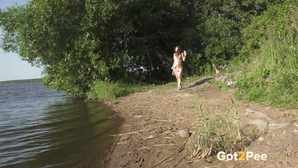 Tall brunette Sasha S squats for an urgent piss on the bank of a lake - #12