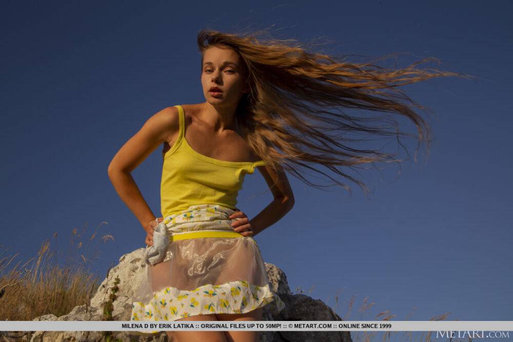 Leggy young girl Milena D shows her full bush while on rocks upon a cliff - #2