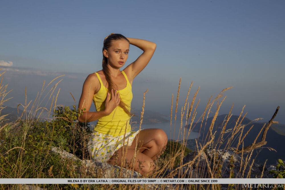 Leggy young girl Milena D shows her full bush while on rocks upon a cliff - #13