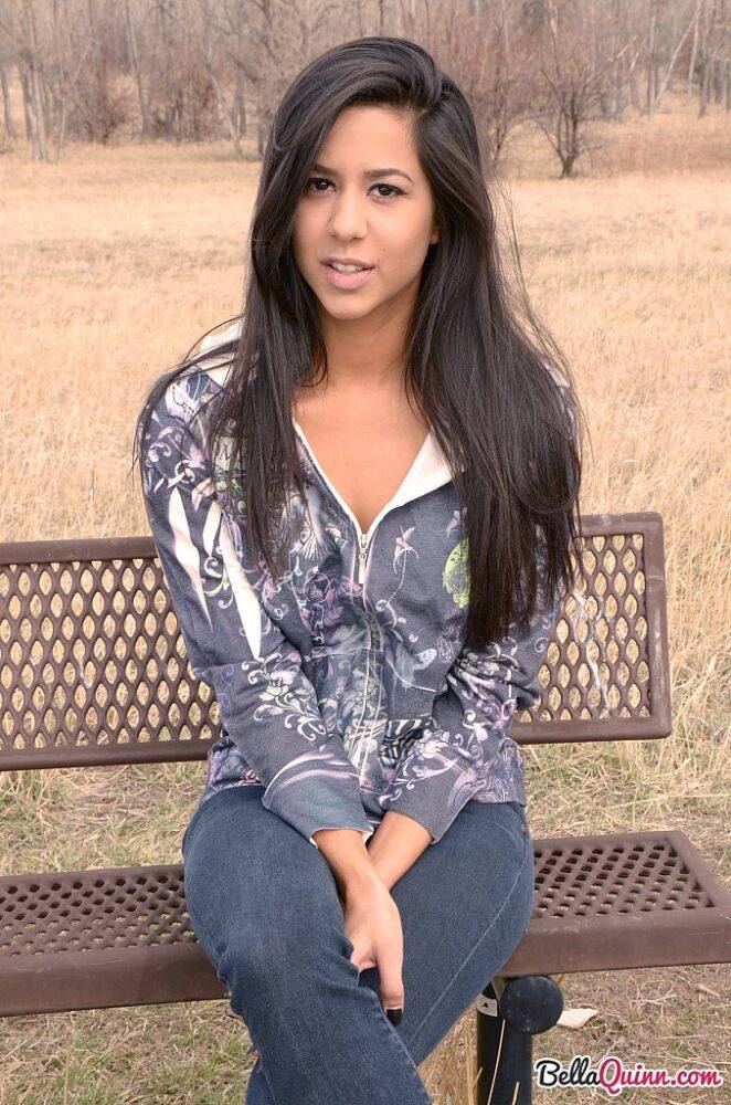 Amateur model Bella Quinn exposes black bra on an outdoor bench | Photo: 1852088