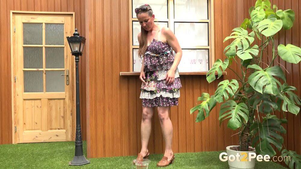 Blonde woman Nicol D hikes short dress to pee standing behind the house - #13