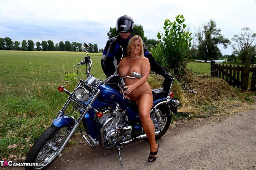 Thick blonde amateur Nude Chrissy poses naked atop a motorcycle on a back road - #3