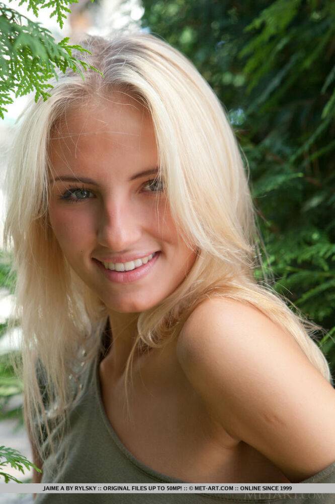 Young blonde female Jaime A stripping off clothes to model naked outdoors - #12