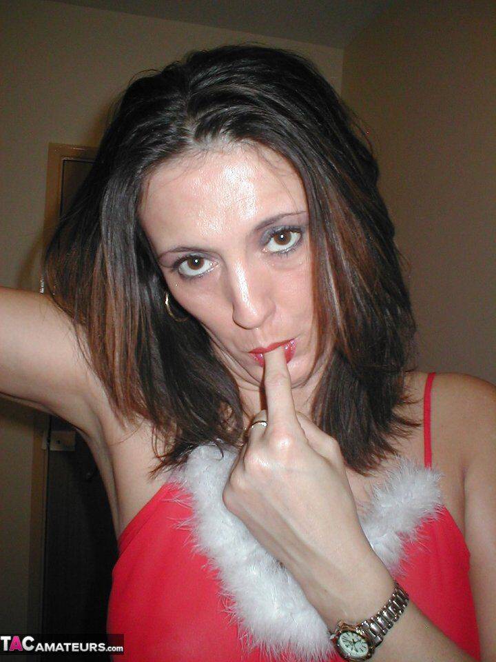 Amateur woman Juicy Jo pauses for a smoke while taking off her Xmas outfit - #14